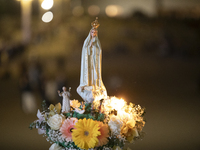 Pilgrims hold candles and pray during the candle procession at the Sanctuary of Fatima, in Fatima, Portugal, on October 12, 2024, on the ann...