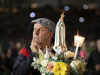 Pilgrims hold candles and pray during the candle procession at the Sanctuary of Fatima, in Fatima, Portugal, on October 12, 2024, on the ann...