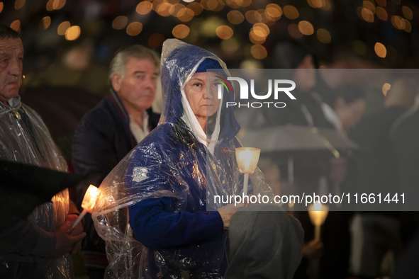 Pilgrims hold candles and pray during the candle procession at the Sanctuary of Fatima, in Fatima, Portugal, on October 12, 2024, on the ann...