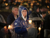 Pilgrims hold candles and pray during the candle procession at the Sanctuary of Fatima, in Fatima, Portugal, on October 12, 2024, on the ann...