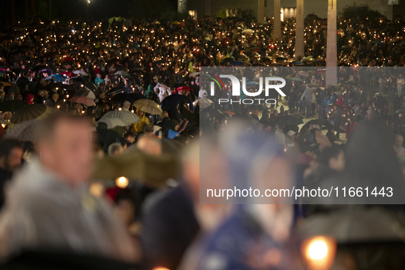 Pilgrims hold candles and pray during the candle procession at the Sanctuary of Fatima, in Fatima, Portugal, on October 12, 2024, on the ann...