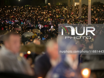 Pilgrims hold candles and pray during the candle procession at the Sanctuary of Fatima, in Fatima, Portugal, on October 12, 2024, on the ann...