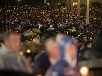 Pilgrims hold candles and pray during the candle procession at the Sanctuary of Fatima, in Fatima, Portugal, on October 12, 2024, on the ann...