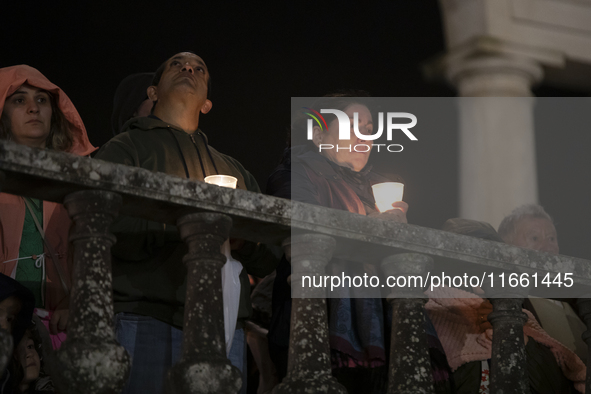 Pilgrims hold candles and pray during the candle procession at the Sanctuary of Fatima, in Fatima, Portugal, on October 12, 2024, on the ann...