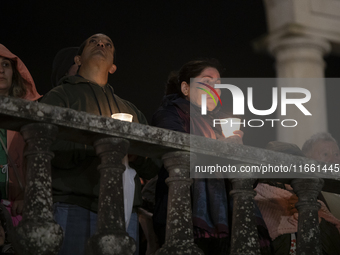 Pilgrims hold candles and pray during the candle procession at the Sanctuary of Fatima, in Fatima, Portugal, on October 12, 2024, on the ann...