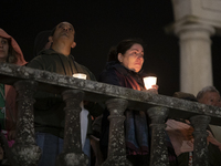 Pilgrims hold candles and pray during the candle procession at the Sanctuary of Fatima, in Fatima, Portugal, on October 12, 2024, on the ann...