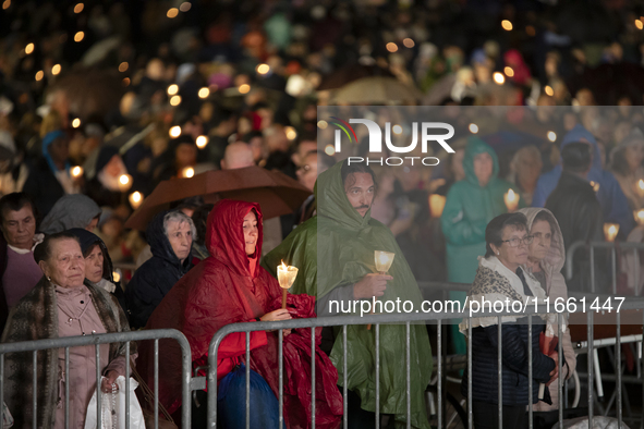 Pilgrims hold candles and pray during the candle procession at the Sanctuary of Fatima, in Fatima, Portugal, on October 12, 2024, on the ann...