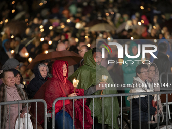 Pilgrims hold candles and pray during the candle procession at the Sanctuary of Fatima, in Fatima, Portugal, on October 12, 2024, on the ann...