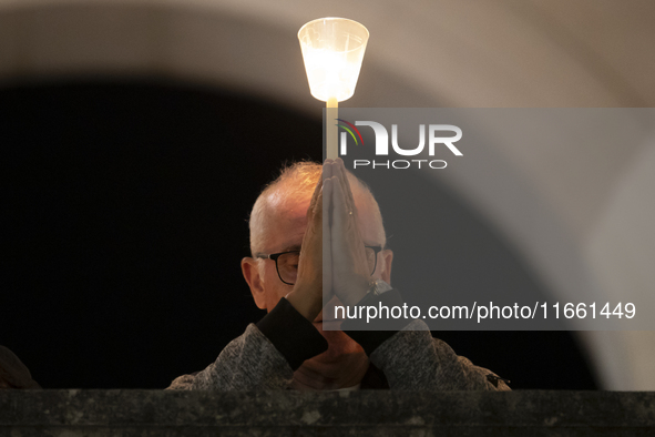 Pilgrims hold candles and pray during the candle procession at the Sanctuary of Fatima, in Fatima, Portugal, on October 12, 2024, on the ann...