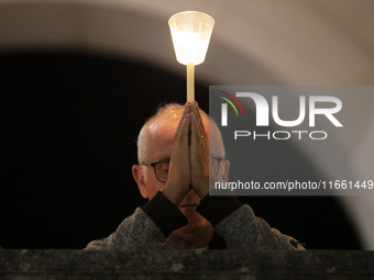 Pilgrims hold candles and pray during the candle procession at the Sanctuary of Fatima, in Fatima, Portugal, on October 12, 2024, on the ann...