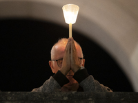 Pilgrims hold candles and pray during the candle procession at the Sanctuary of Fatima, in Fatima, Portugal, on October 12, 2024, on the ann...