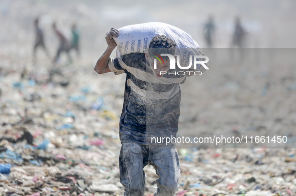 A photo shows Palestinian youths collecting remains of spoiled flour discarded in a makeshift landfill near the tents of displaced people in...