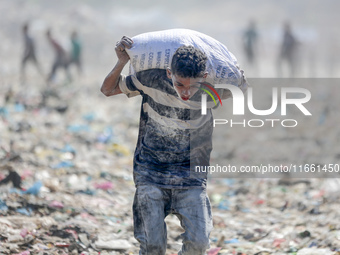 A photo shows Palestinian youths collecting remains of spoiled flour discarded in a makeshift landfill near the tents of displaced people in...