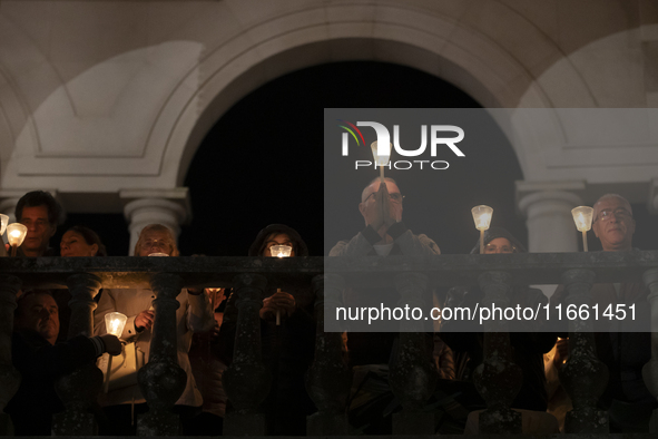 Pilgrims hold candles and pray during the candle procession at the Sanctuary of Fatima, in Fatima, Portugal, on October 12, 2024, on the ann...