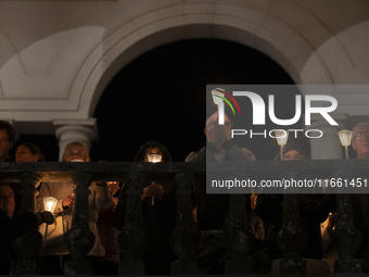 Pilgrims hold candles and pray during the candle procession at the Sanctuary of Fatima, in Fatima, Portugal, on October 12, 2024, on the ann...