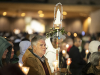 Pilgrims hold candles and pray during the candle procession at the Sanctuary of Fatima, in Fatima, Portugal, on October 12, 2024, on the ann...