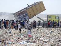 A photo shows Palestinian youths collecting remains of spoiled flour discarded in a makeshift landfill near the tents of displaced people in...