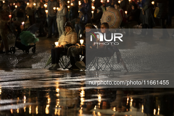 Pilgrims hold candles and pray during the candle procession at the Sanctuary of Fatima, in Fatima, Portugal, on October 12, 2024, on the ann...