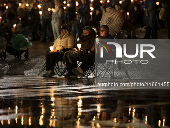 Pilgrims hold candles and pray during the candle procession at the Sanctuary of Fatima, in Fatima, Portugal, on October 12, 2024, on the ann...