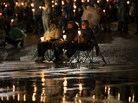 Pilgrims hold candles and pray during the candle procession at the Sanctuary of Fatima, in Fatima, Portugal, on October 12, 2024, on the ann...