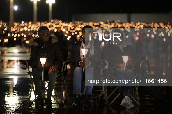 Pilgrims hold candles and pray during the candle procession at the Sanctuary of Fatima, in Fatima, Portugal, on October 12, 2024, on the ann...