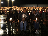 Pilgrims hold candles and pray during the candle procession at the Sanctuary of Fatima, in Fatima, Portugal, on October 12, 2024, on the ann...