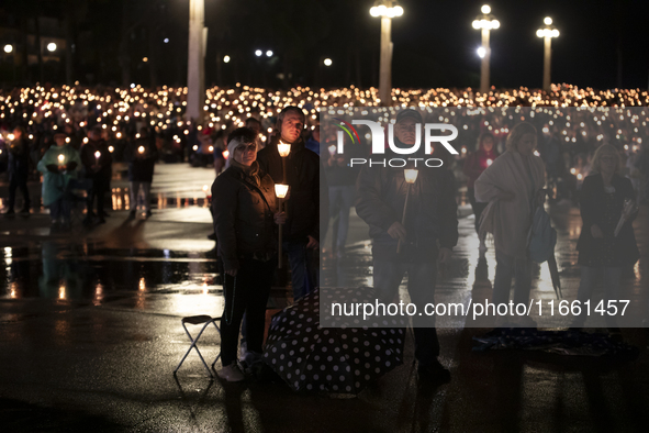 Pilgrims hold candles and pray during the candle procession at the Sanctuary of Fatima, in Fatima, Portugal, on October 12, 2024, on the ann...