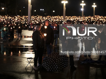 Pilgrims hold candles and pray during the candle procession at the Sanctuary of Fatima, in Fatima, Portugal, on October 12, 2024, on the ann...