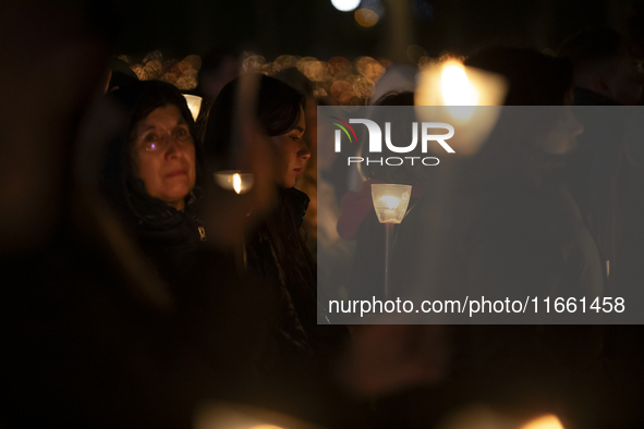 Pilgrims hold candles and pray during the candle procession at the Sanctuary of Fatima, in Fatima, Portugal, on October 12, 2024, on the ann...