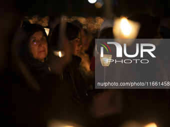 Pilgrims hold candles and pray during the candle procession at the Sanctuary of Fatima, in Fatima, Portugal, on October 12, 2024, on the ann...