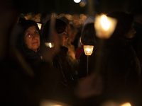 Pilgrims hold candles and pray during the candle procession at the Sanctuary of Fatima, in Fatima, Portugal, on October 12, 2024, on the ann...