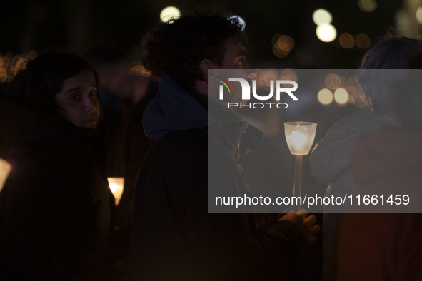 Pilgrims hold candles and pray during the candle procession at the Sanctuary of Fatima, in Fatima, Portugal, on October 12, 2024, on the ann...