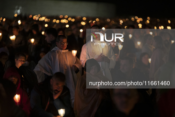 Pilgrims hold candles and pray during the candle procession at the Sanctuary of Fatima, in Fatima, Portugal, on October 12, 2024, on the ann...