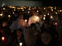 Pilgrims hold candles and pray during the candle procession at the Sanctuary of Fatima, in Fatima, Portugal, on October 12, 2024, on the ann...