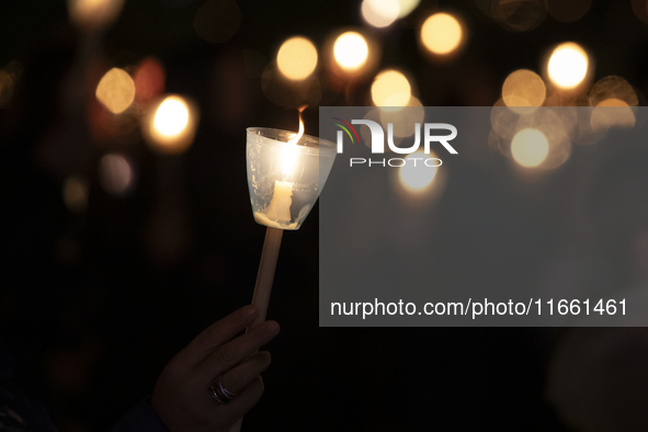 Pilgrims hold candles and pray during the candle procession at the Sanctuary of Fatima, in Fatima, Portugal, on October 12, 2024, on the ann...