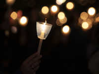 Pilgrims hold candles and pray during the candle procession at the Sanctuary of Fatima, in Fatima, Portugal, on October 12, 2024, on the ann...