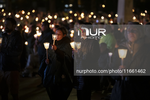 Pilgrims hold candles and pray during the candle procession at the Sanctuary of Fatima, in Fatima, Portugal, on October 12, 2024, on the ann...