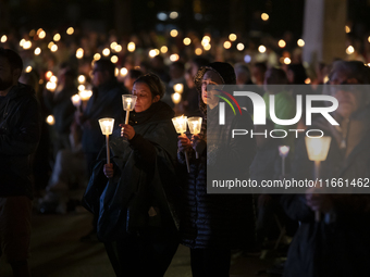 Pilgrims hold candles and pray during the candle procession at the Sanctuary of Fatima, in Fatima, Portugal, on October 12, 2024, on the ann...