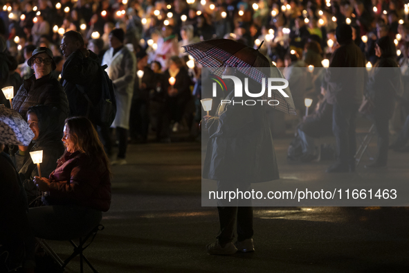 Pilgrims hold candles and pray during the candle procession at the Sanctuary of Fatima, in Fatima, Portugal, on October 12, 2024, on the ann...