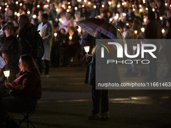 Pilgrims hold candles and pray during the candle procession at the Sanctuary of Fatima, in Fatima, Portugal, on October 12, 2024, on the ann...