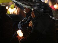 Pilgrims hold candles and pray during the candle procession at the Sanctuary of Fatima, in Fatima, Portugal, on October 12, 2024, on the ann...