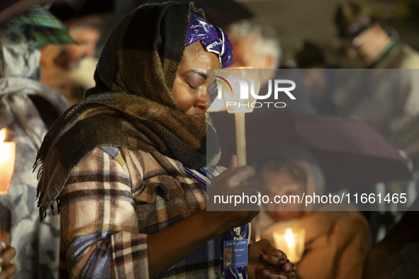 Pilgrims hold candles and pray during the candle procession at the Sanctuary of Fatima, in Fatima, Portugal, on October 12, 2024, on the ann...