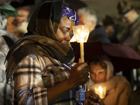 Pilgrims hold candles and pray during the candle procession at the Sanctuary of Fatima, in Fatima, Portugal, on October 12, 2024, on the ann...