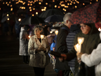 Pilgrims hold candles and pray during the candle procession at the Sanctuary of Fatima, in Fatima, Portugal, on October 12, 2024, on the ann...