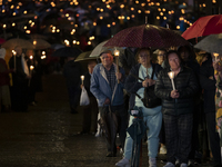 Pilgrims hold candles and pray during the candle procession at the Sanctuary of Fatima, in Fatima, Portugal, on October 12, 2024, on the ann...