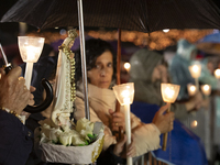 Pilgrims hold candles and pray during the candle procession at the Sanctuary of Fatima, in Fatima, Portugal, on October 12, 2024, on the ann...