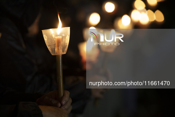 Pilgrims hold candles and pray during the candle procession at the Sanctuary of Fatima, in Fatima, Portugal, on October 12, 2024, on the ann...