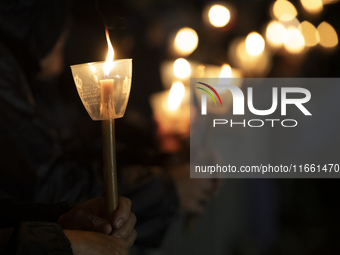 Pilgrims hold candles and pray during the candle procession at the Sanctuary of Fatima, in Fatima, Portugal, on October 12, 2024, on the ann...