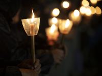 Pilgrims hold candles and pray during the candle procession at the Sanctuary of Fatima, in Fatima, Portugal, on October 12, 2024, on the ann...