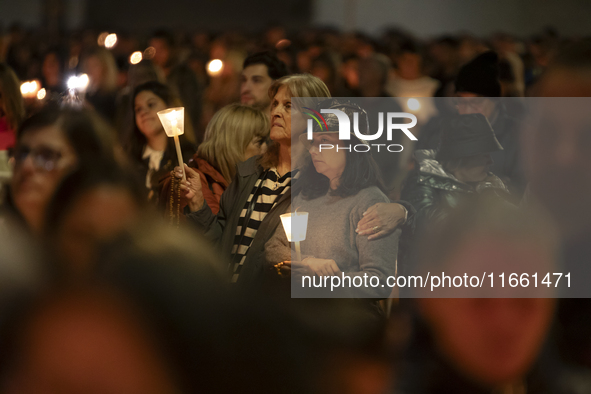 Pilgrims hold candles and pray during the candle procession at the Sanctuary of Fatima, in Fatima, Portugal, on October 12, 2024, on the ann...